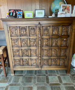 Antique Cabinet With Carved Coats Of Arms And Heads On The Front